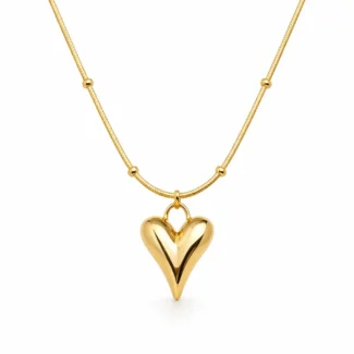 Gold Alphalurent titanium steel necklace featuring a smooth, 3D geometric heart pendant on a beaded snake chain.
