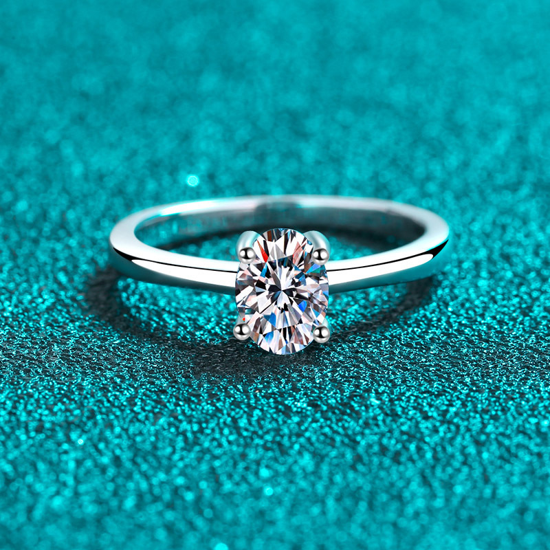 Alphalurent solid silver solitaire ring featuring a brilliant oval-cut center stone secured by a classic four-prong setting on a sleek, plain band.