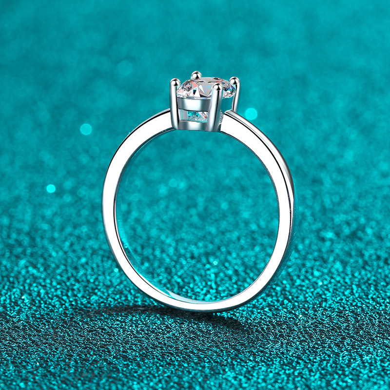 Alphalurent solid silver solitaire ring featuring a brilliant oval-cut center stone secured by a classic four-prong setting on a sleek, plain band.