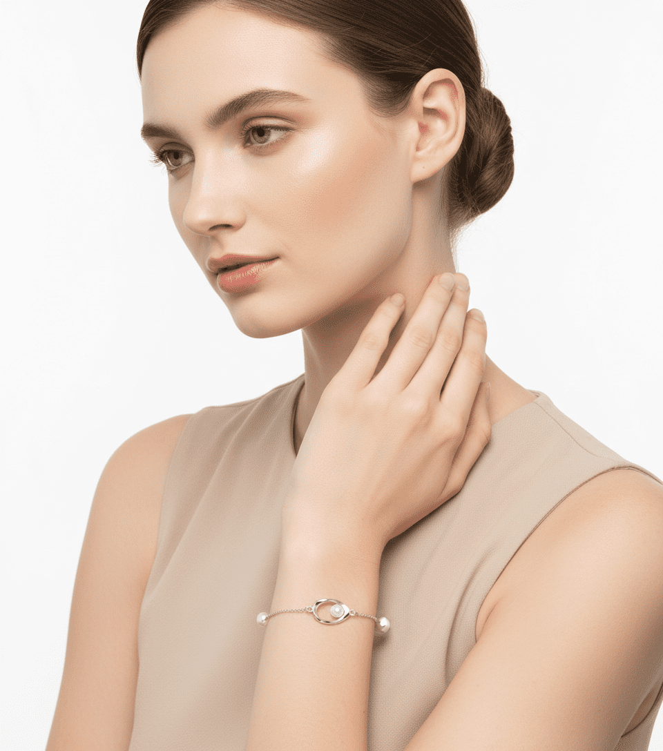 Alphalurent 925 silver necklace featuring a geometric Möbius twist pendant holding a single white pearl. (For the gold bracelet image): Gold-plated Alphalurent bracelet with a twisted pearl charm and two accent pearls on a delicate chain.