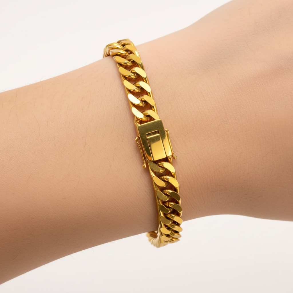 Alphalurent Bold Gold Cuban Link Bracelet | 5.3mm Titanium Steel Chain Alphalurent gold titanium steel Cuban chain bracelet on wrist featuring a secure fold-over clasp and 5.3mm flat links.