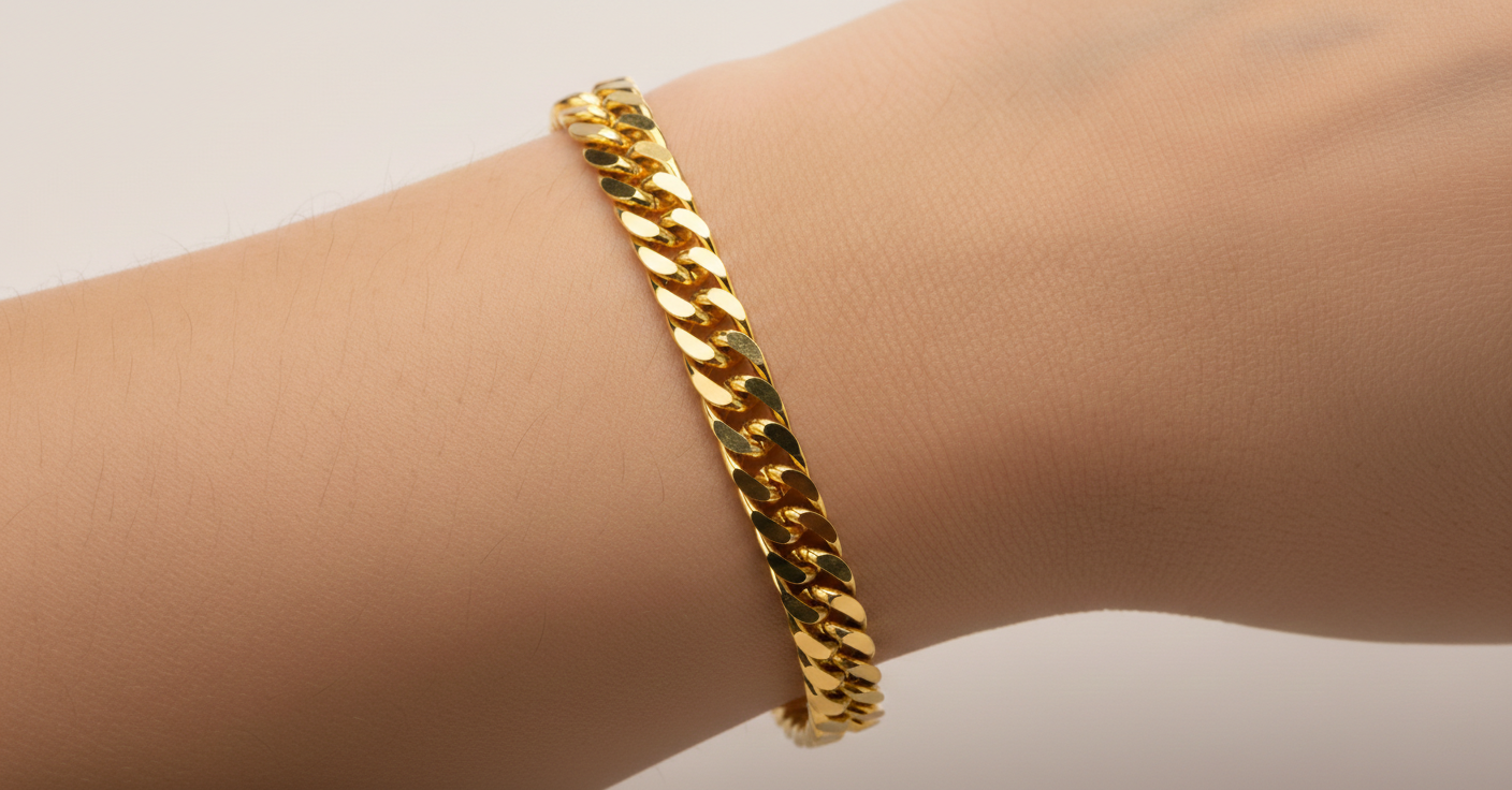 Alphalurent Bold Gold Cuban Link Bracelet | 5.3mm Titanium Steel Chain Alphalurent gold titanium steel Cuban chain bracelet on wrist featuring a secure fold-over clasp and 5.3mm flat links.