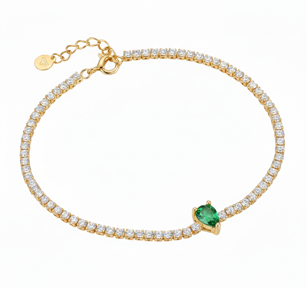 Alphalurent gold tennis bracelet featuring a single heart-shaped red zircon stone. (For the green image): Alphalurent gold vermeil tennis bracelet with a teardrop pear-shaped emerald green zircon.
