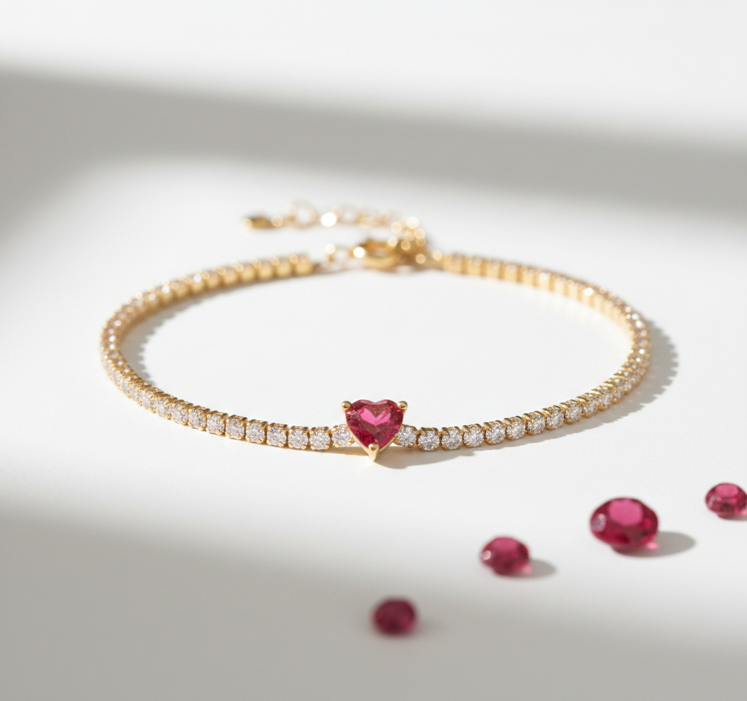 Alphalurent gold tennis bracelet featuring a single heart-shaped red zircon stone. (For the green image): Alphalurent gold vermeil tennis bracelet with a teardrop pear-shaped emerald green zircon.