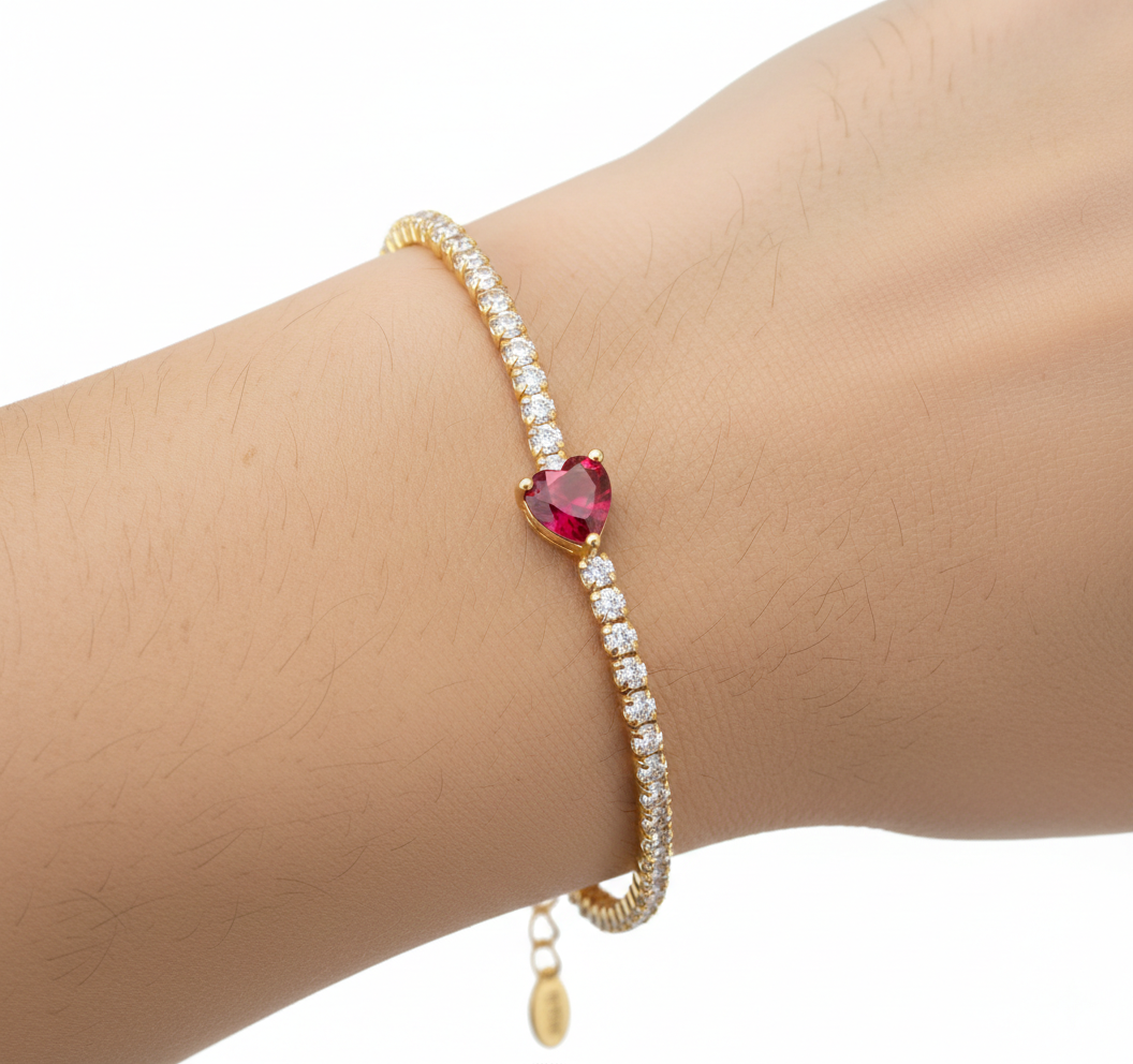 Alphalurent gold tennis bracelet featuring a single heart-shaped red zircon stone. (For the green image): Alphalurent gold vermeil tennis bracelet with a teardrop pear-shaped emerald green zircon.