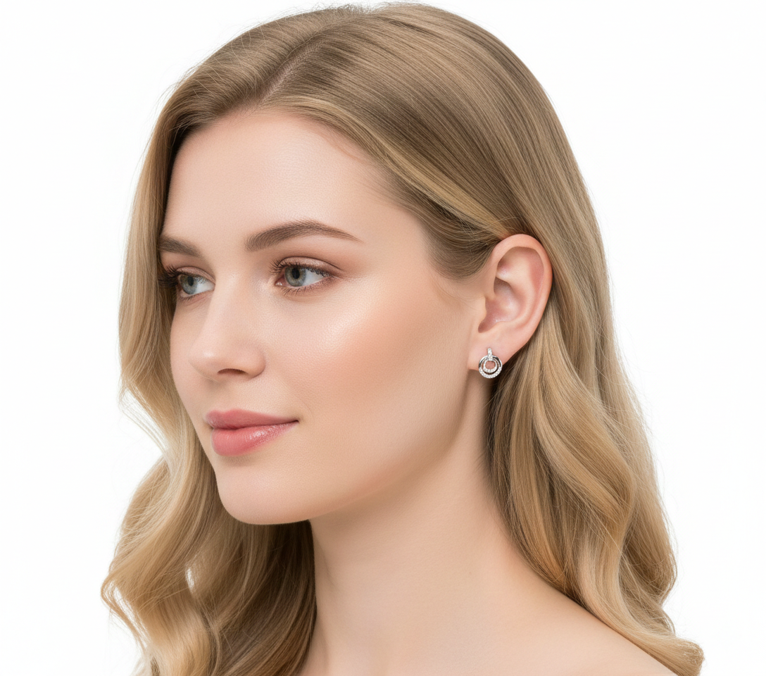 Alphalurent 925 sterling silver stud earrings featuring a geometric design with two interlocking circles, accented with sparkling pave crystals.