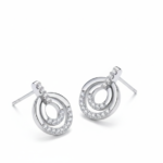Alphalurent 925 sterling silver stud earrings featuring a geometric design with two interlocking circles, accented with sparkling pave crystals.