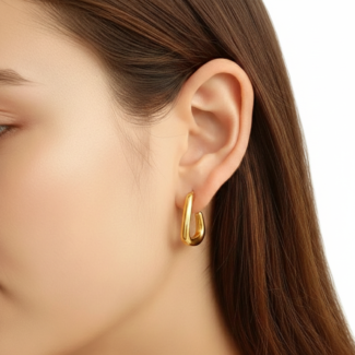 Alphalurent gold titanium steel hoop earrings featuring an irregular, fluid U-shape geometric design. (For the silver image): Model wearing Alphalurent asymmetric silver U-shaped hoop earrings with a sleek, modern finish.