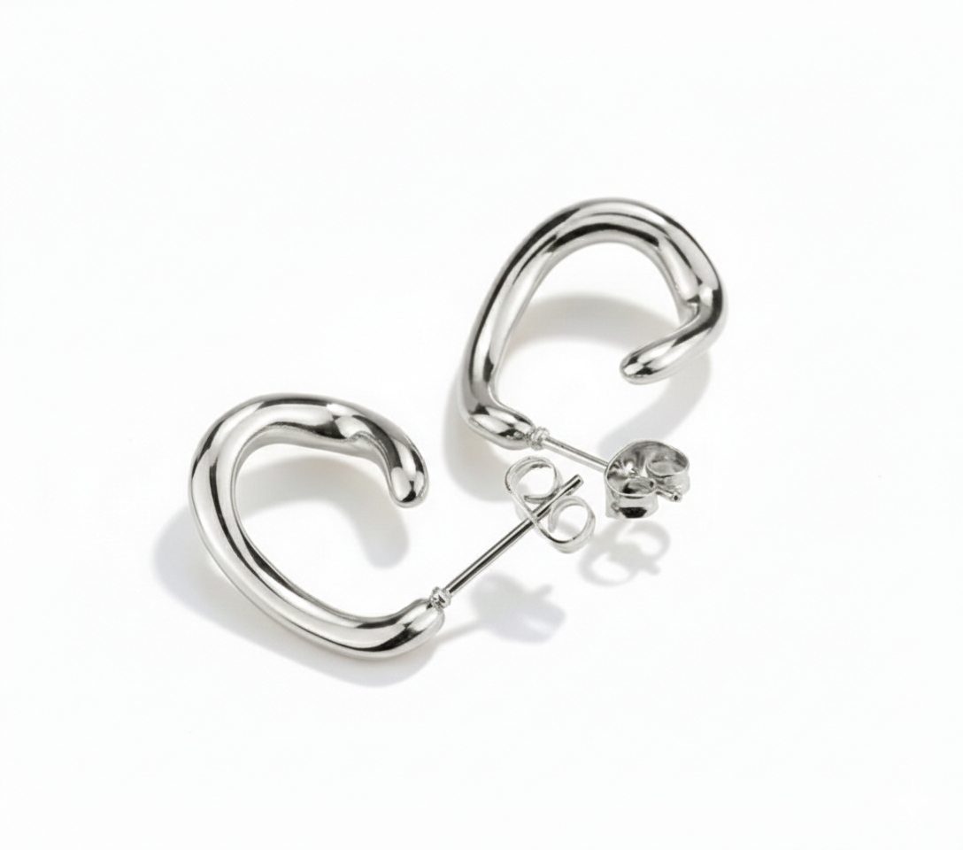 Alphalurent gold titanium steel hoop earrings featuring an irregular, fluid U-shape geometric design. (For the silver image): Model wearing Alphalurent asymmetric silver U-shaped hoop earrings with a sleek, modern finish.