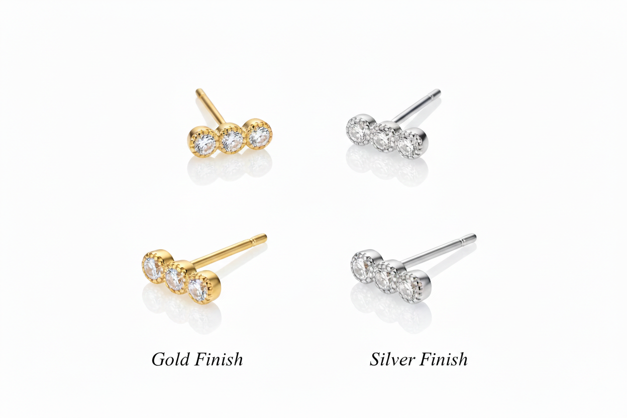 Alphalurent 925 sterling silver minimalist stud earrings featuring a geometric row of three crystals with a textured beaded edge, shown in gold and silver finishes. (For the model images): Model wearing delicate Alphalurent gold tri-gem geometric stud earrings.