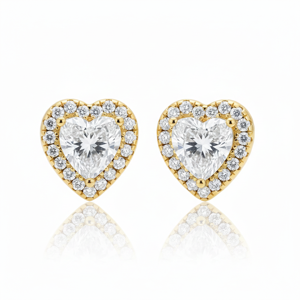 Alphalurent Stellar Heart Halo Stud Earrings | 14K Gold Plated 925 Sterling Silver Alphalurent gold-plated 925 silver stud earrings featuring a large clear heart-shaped crystal surrounded by a halo of smaller pave stones.