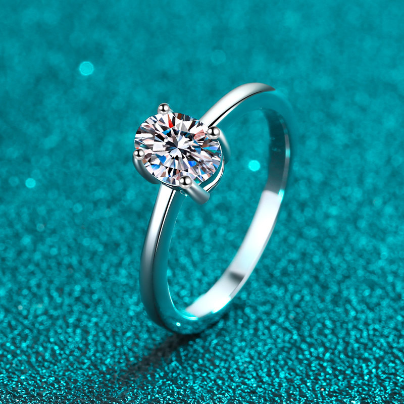 Alphalurent solid silver solitaire ring featuring a brilliant oval-cut center stone secured by a classic four-prong setting on a sleek, plain band.