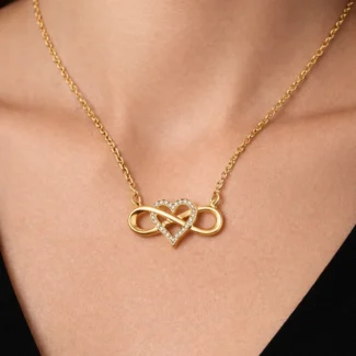 Infinity Lume gold plated necklace with infinity heart pendant and zircon center on velvet background