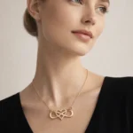 Infinity Lume gold plated necklace with infinity heart pendant and zircon center on velvet background