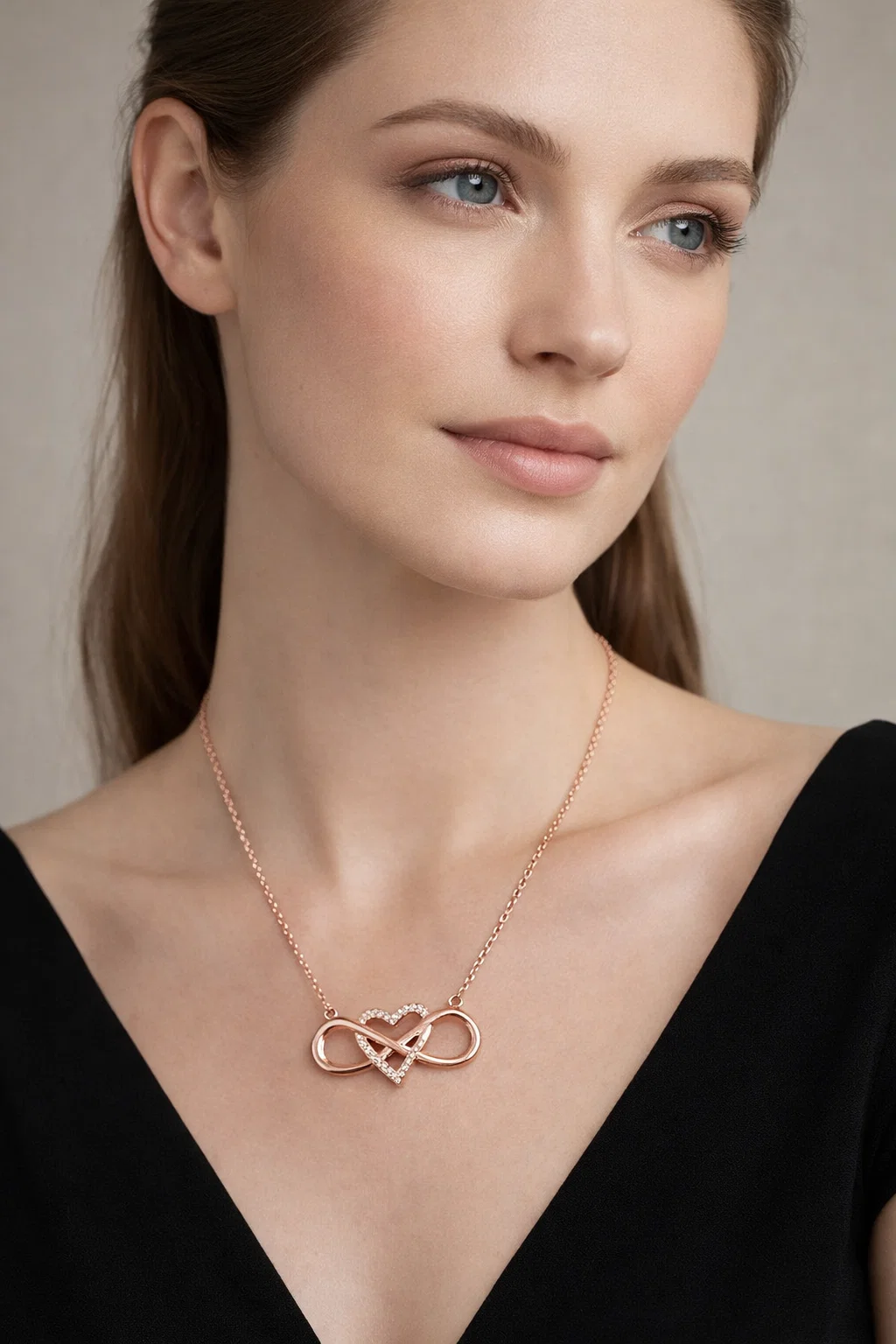 Rose gold infinity heart necklace with sparkling zircon worn with casual denim and white shirt