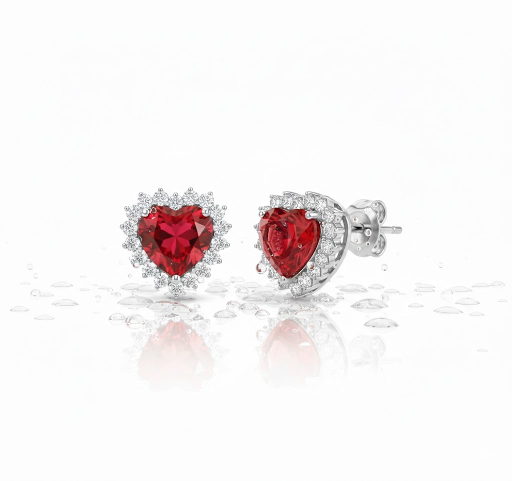 Alphalurent Crimson Heart Halo Stud Earrings | Red Zirconia in White Gold Plated 925 Silver Alphalurent 925 sterling silver stud earrings featuring a vibrant red heart-shaped cubic zirconia surrounded by a sparkling white halo. (For the model image): Model wearing Alphalurent white gold plated silver earrings with a red heart halo design.