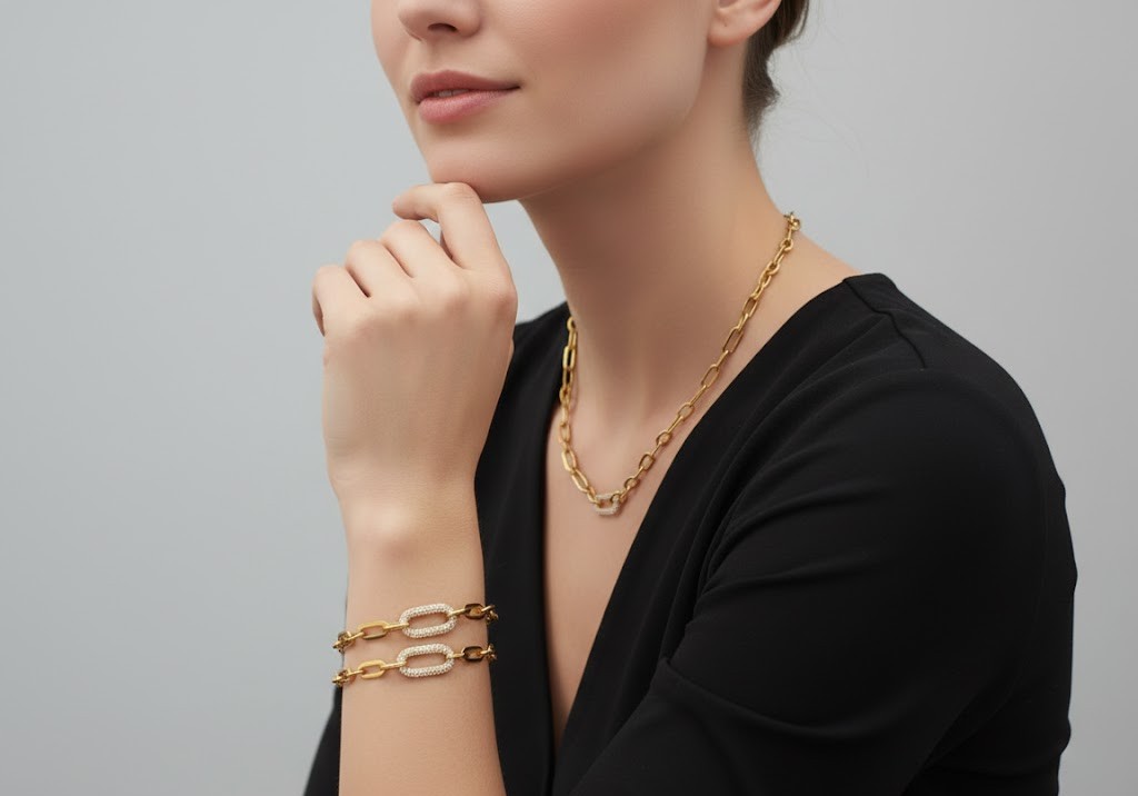 Alphalurent gold paperclip chain necklace featuring a central oval link completely encrusted with sparkling pave cubic zirconia stones.