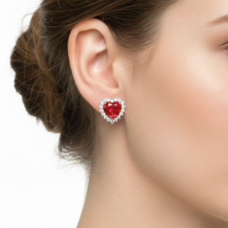 Alphalurent 925 sterling silver stud earrings featuring a vibrant red heart-shaped cubic zirconia surrounded by a sparkling white halo. (For the model image): Model wearing Alphalurent white gold plated silver earrings with a red heart halo design.