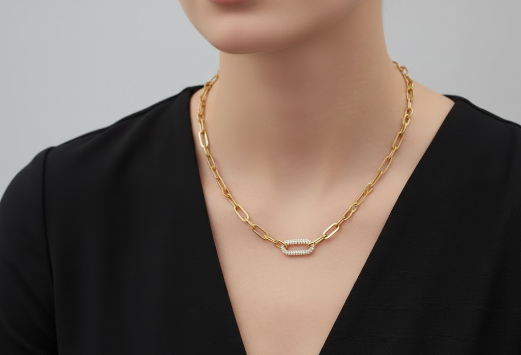 Alphalurent gold paperclip chain necklace featuring a central oval link completely encrusted with sparkling pave cubic zirconia stones.
