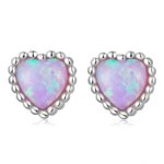 Alphalurent 925 sterling silver stud earrings featuring a heart-shaped iridescent blue opal crystal, a beaded silver edge, and comfortable screw-on ball backs.